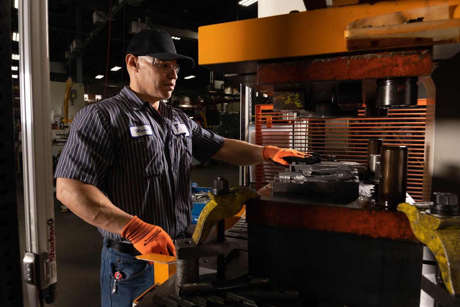 An operator working at a stamping press